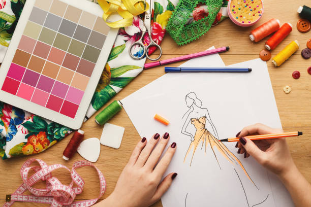 istock Top view on woman designer drawing clothes sketches 912443682