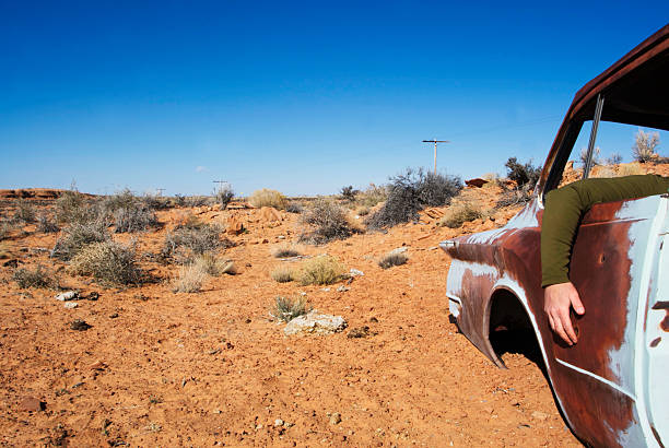 istock junked desert car and human arm 91244508