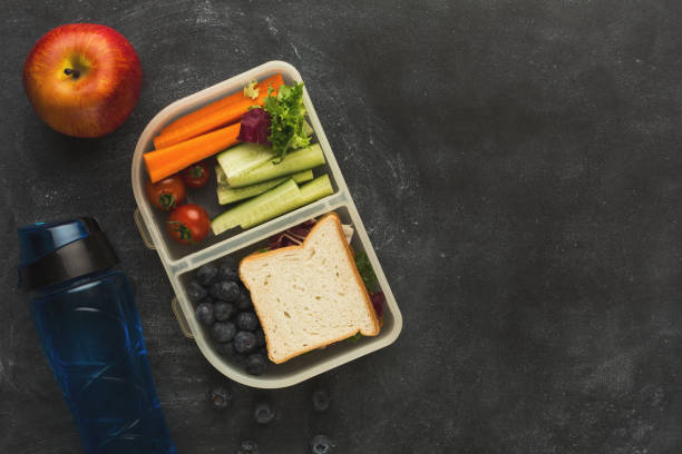 istock Lunch box with healthy food on black table background 912446244