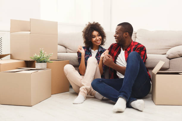 istock Young balck couple unpacking moving boxes 912447728