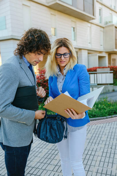 istock Businesspeople checking documents in the street 912453618