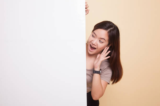 istock Excited young Asian woman with blank sign. 912457710