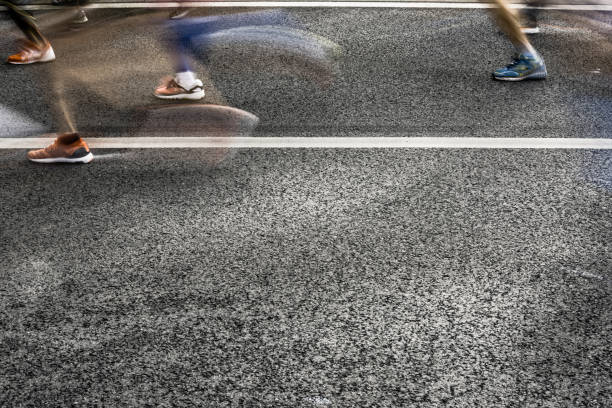 istock People running in marathon on city streets. Motion blur. 912458142