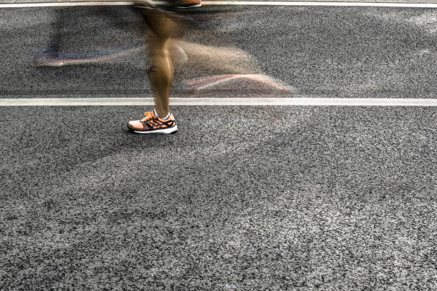 istock People running in marathon on city streets. Motion blur. 912458202