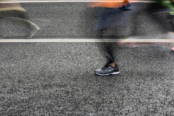 istock People running in marathon on city streets. Motion blur. 912458208