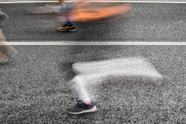 istock People running in marathon on city streets. Motion blur. 912458254