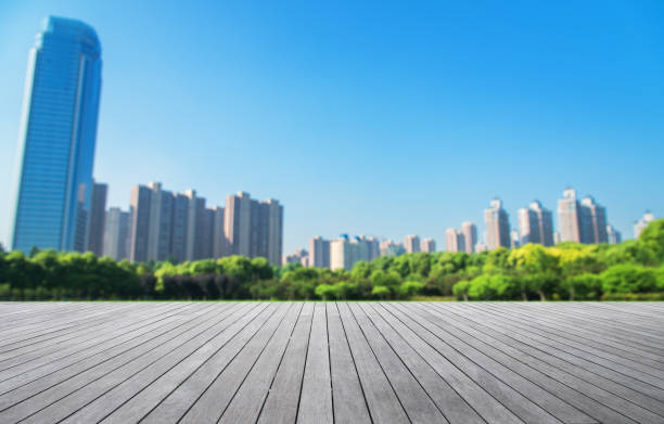 istock Wooden platform and modern city blurred abstract background 912460536