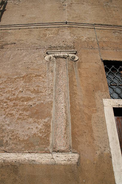 Roman column in a wall ´s house. Rome stock photo