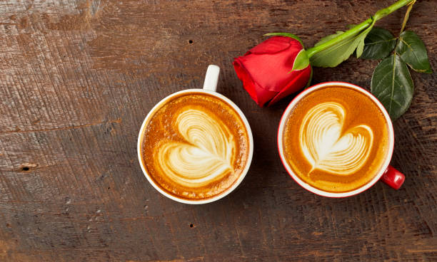 istock cappuccino with red rose on wood table 912462100