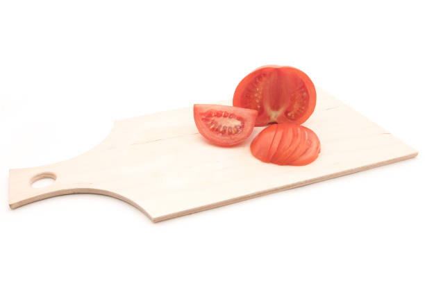 Tomato sliced on a wooden board for any purpose