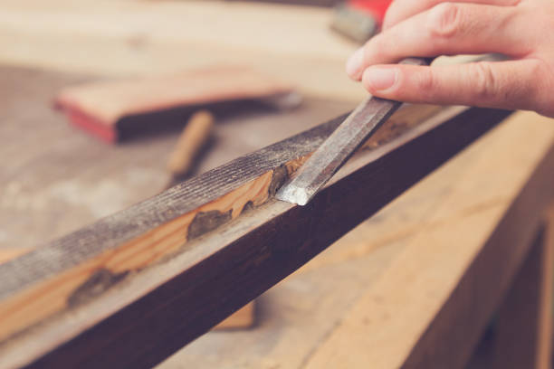 istock Male carpenter working on raw wood / boards / plank. 912462780