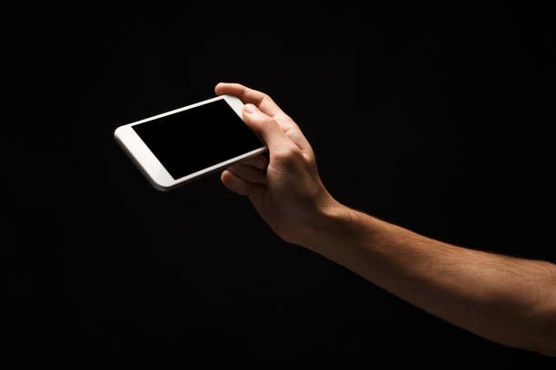 istock Male hand holding mobile smartphone with blank screen 912466248