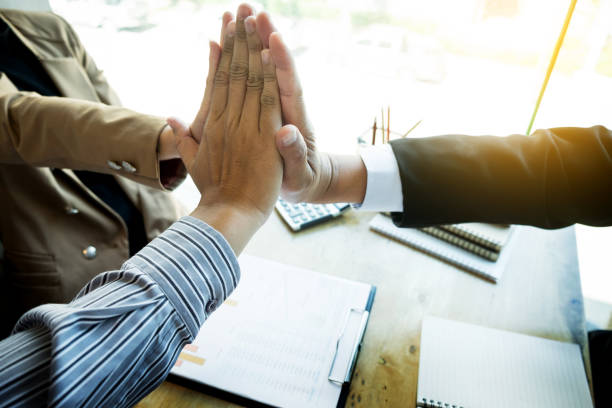 istock Cropped Image Of Business People Joining Hands In Office 912468384