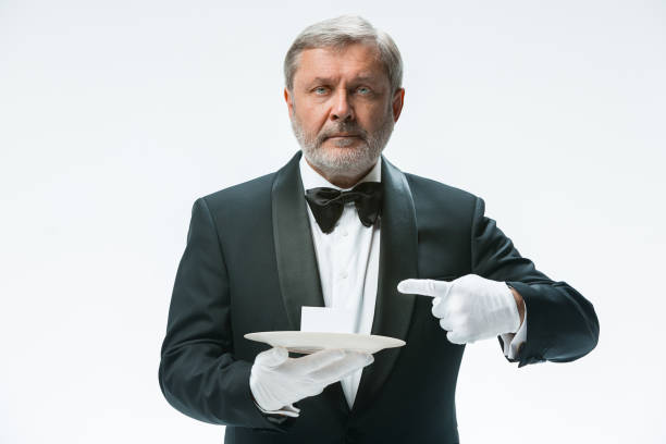 istock Senior waiter holding tray 912468590
