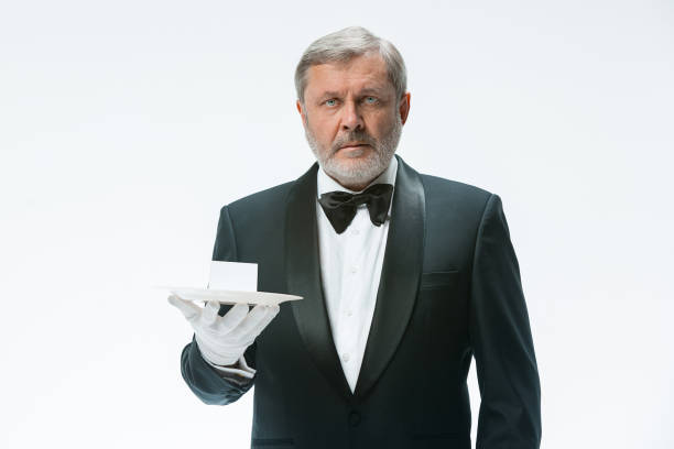istock Senior waiter holding tray 912470858