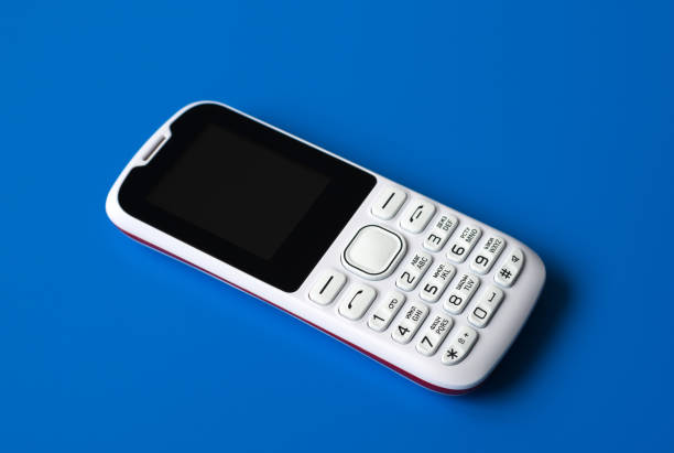 istock White cell phone with buttons on blue background 912473522