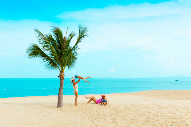 istock Woman with baby on the beach 912481578