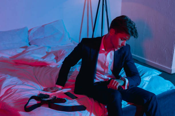 istock businessman sitting on bed in dark room 912482792