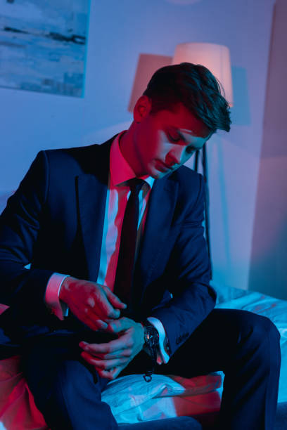 istock businessman taking off his watch 912490002