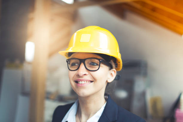 istock young blond female architect with yellow helmet 912490828