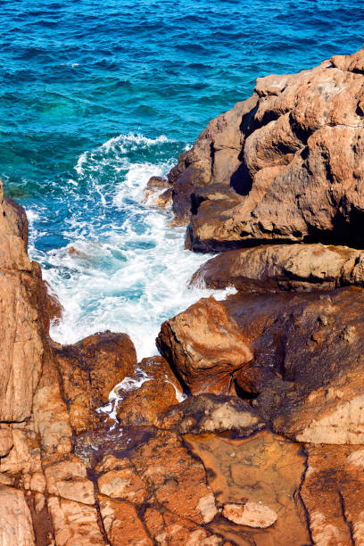 istock Top down view of cliffs, rocks and a turquoise sea 912491330