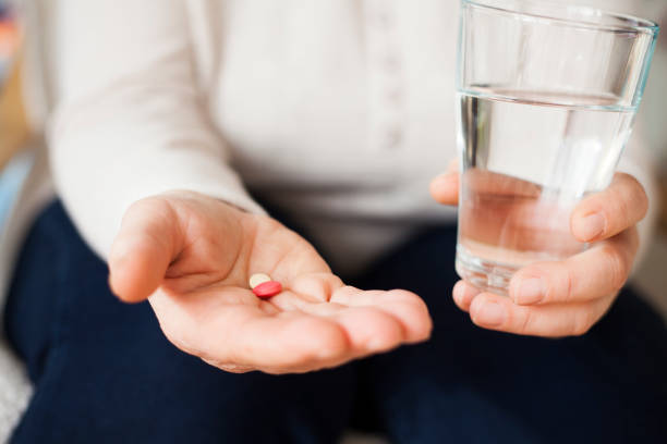 istock senior woman taking pills 912497782