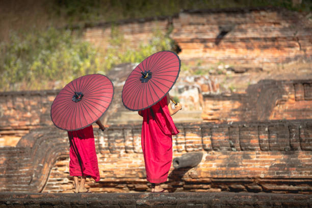 istock Two novices spread a red umbrella 912497956