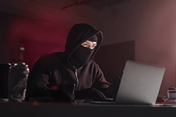istock Serious computer fraudster noting in laptop 912501922
