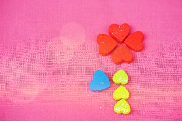 istock one flower for many small hearts on pink background,Top view and copy space 912504712