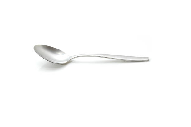 Single spoon agains a white background Single spoon on a white background teaspoon stock pictures, royalty-free photos & images