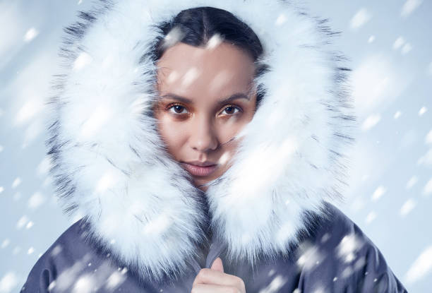 istock Beautiful charming hispanic girl in blue coat with falling snow 912505628