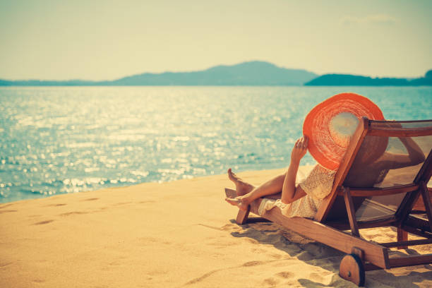 istock Woman in beach chair 912506134