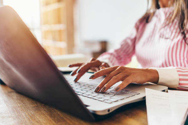 istock Female hands typing on laptop computer at her workplace 912507482