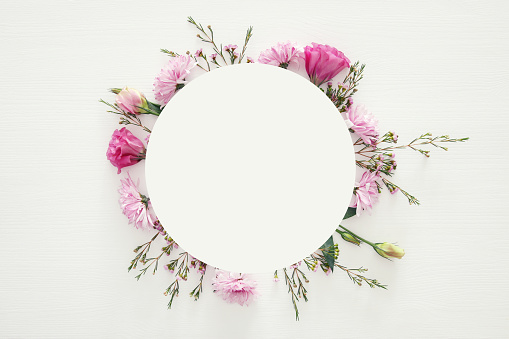 Top view of beautiful flowers arrangement on white wooden background. Copy space