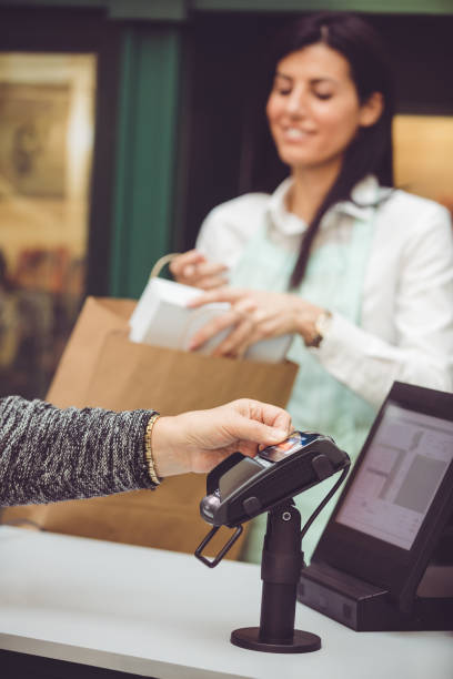 istock Senior woman paying contactless using credit card 912509554