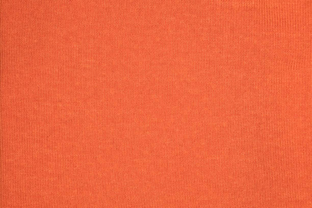 istock fabric in orange color, close-up on the stitch 912511062