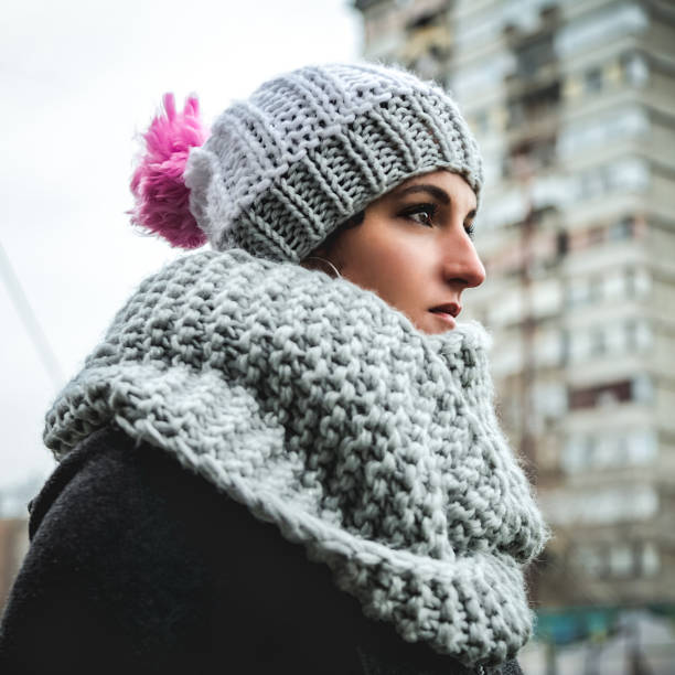 WINTER SEASON. Beautiful happy excited mixed race student woman smiling at camera posing at snowy forest slow motion. Positive attractive female student with curly hair enjoying holidays outdoors.