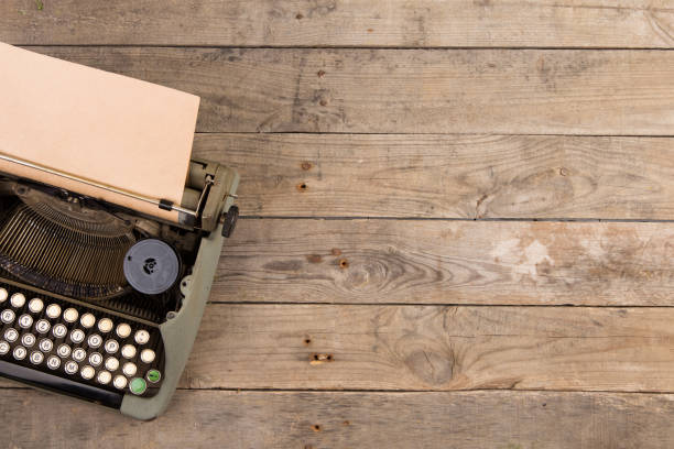istock Vintage typewriter on the old wooden desk 912514332