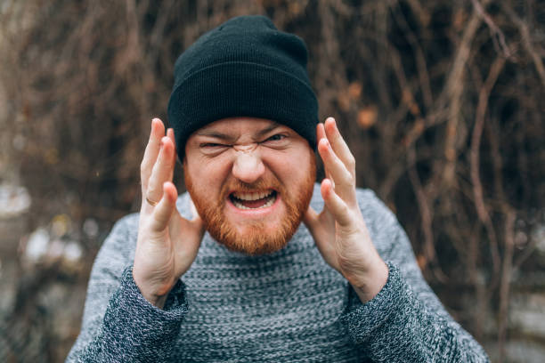 istock young Redhead  bearded in a sweater  and cap, outside 912514338