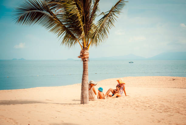 istock Woman with baby on the beach 912522136