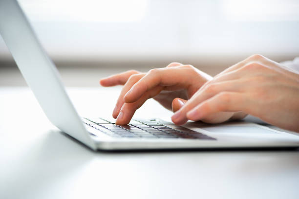 close-up of hands of business man typing on a laptop. - user access imagens e fotografias de stock