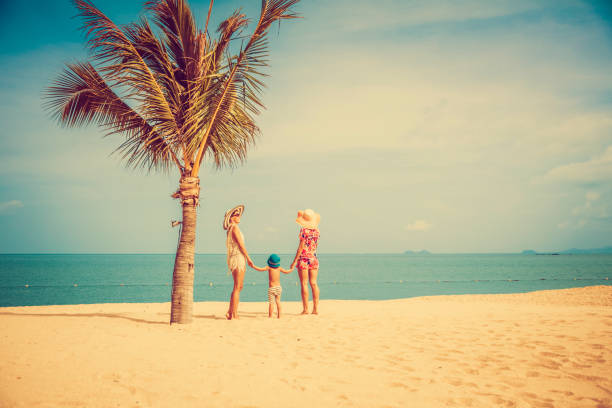 istock Woman with baby on the beach 912525566
