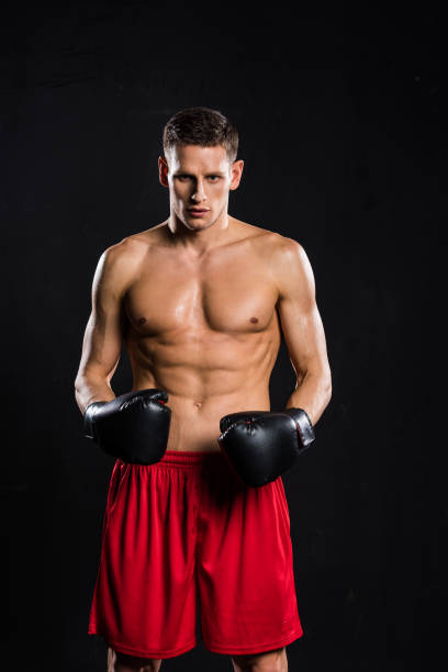 istock young muscular shirtless boxer looking at camera isolated on black 912534974