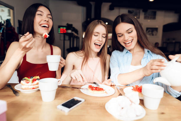 istock Three girls are sitting together in a cafe. 912549950