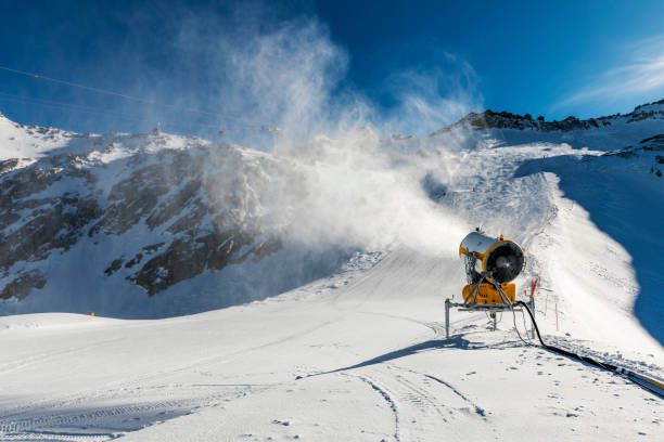 istock snowmaking - snow cannon working on the slope 912552444