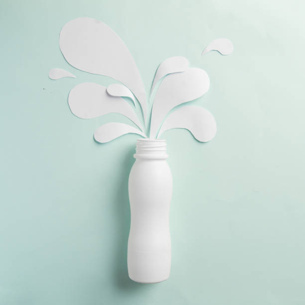 istock Yogurt bottle with white paper splashes 912554338