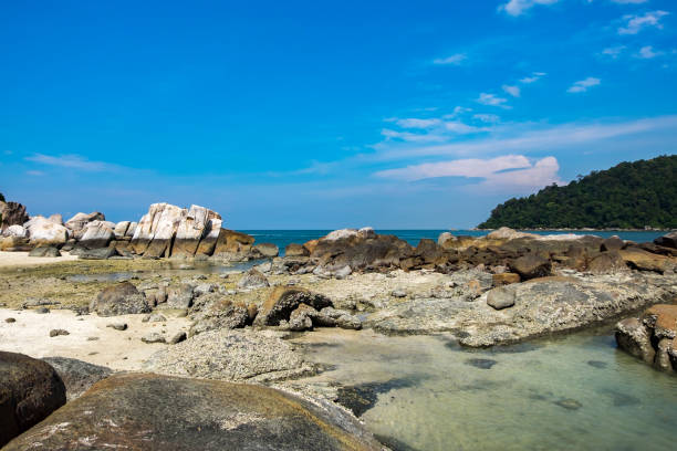 istock Rock Formations By Sea Against Blue Sky 912554374