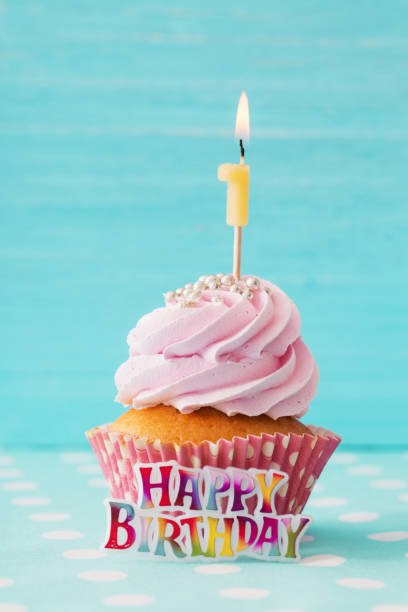 istock birthday caucpcake on blue wooden background 912560790