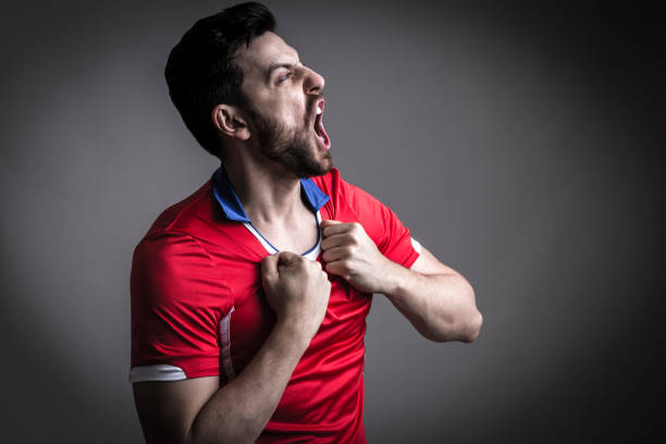 istock Fan / Sport Player on red uniform celebrating 912561630
