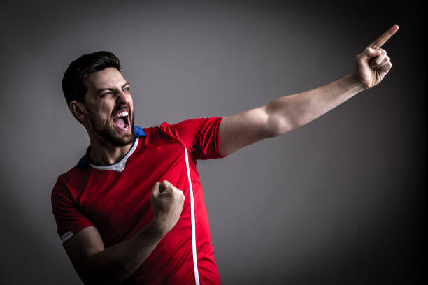 istock Fan / Sport Player on red uniform celebrating 912561658